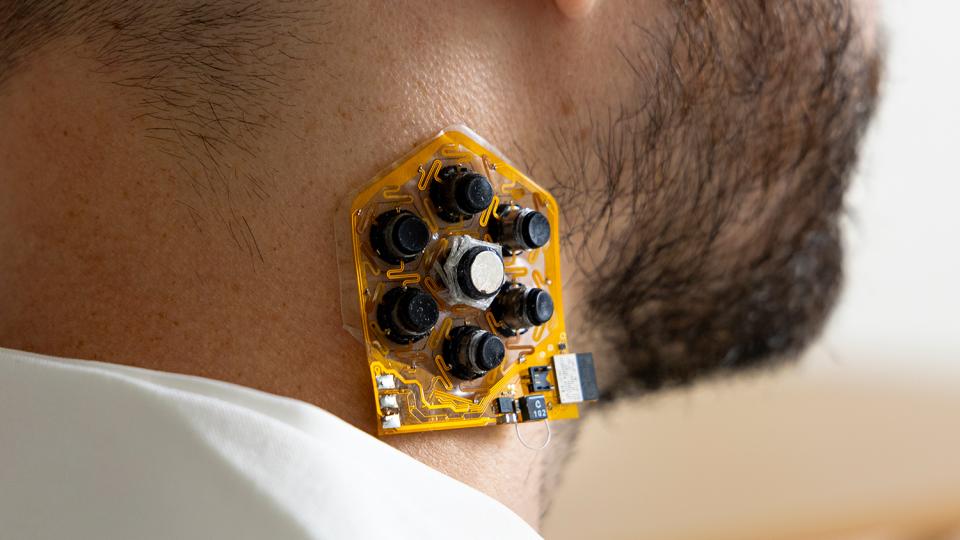 a patch of haptic actuators shown on a user's neck